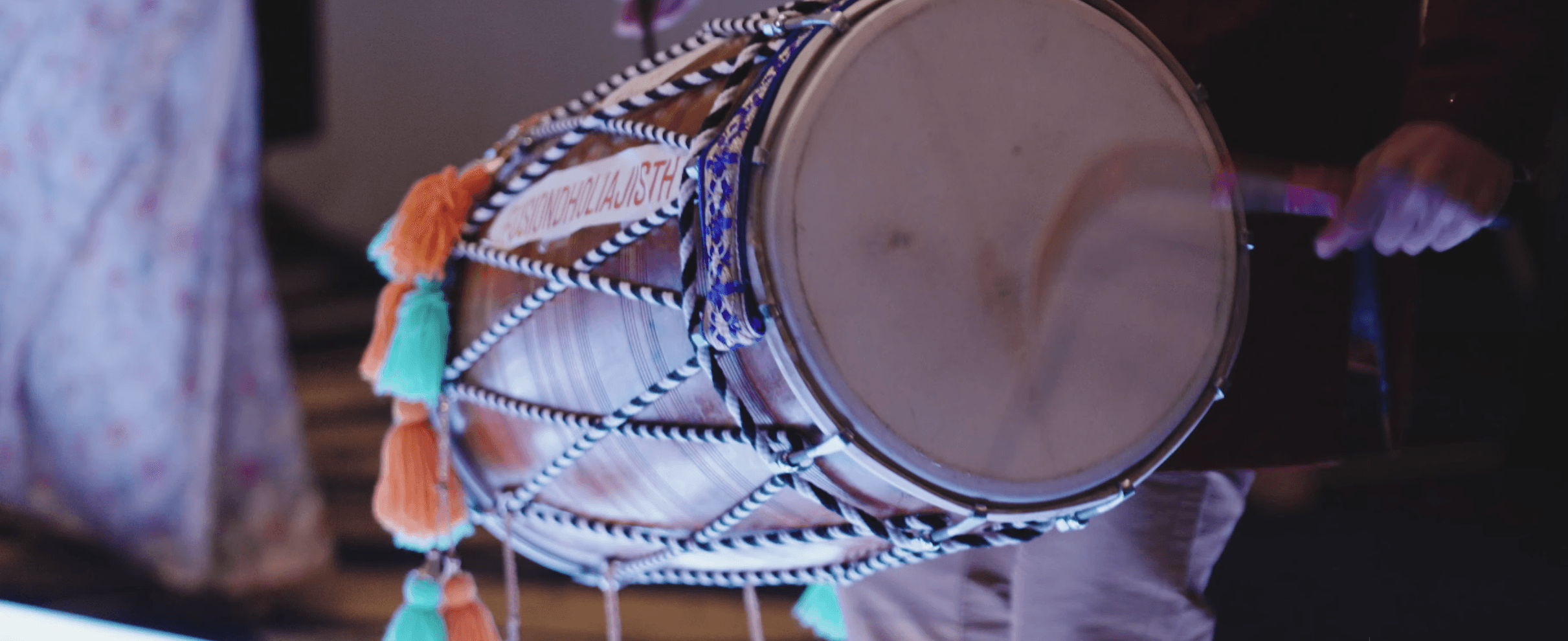 Wide shot of a dhol performance at a festival