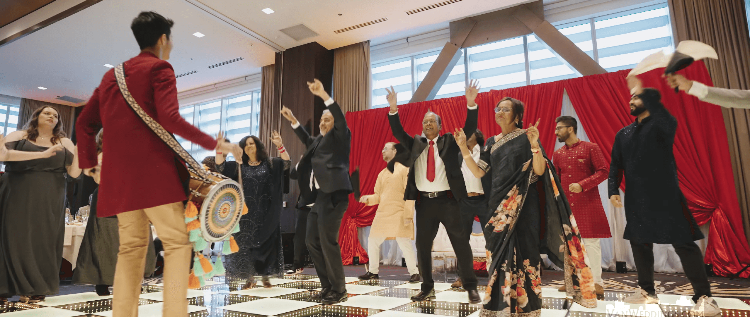 Ajisth performing dhol at a wedding entrance